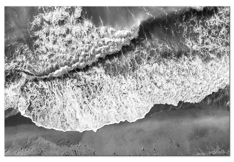 Ocean shore - black and white photograph of waves hitting the beach