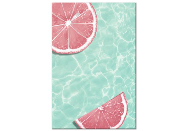 Grapefruit slices floating in turquoise water - summer abstraction