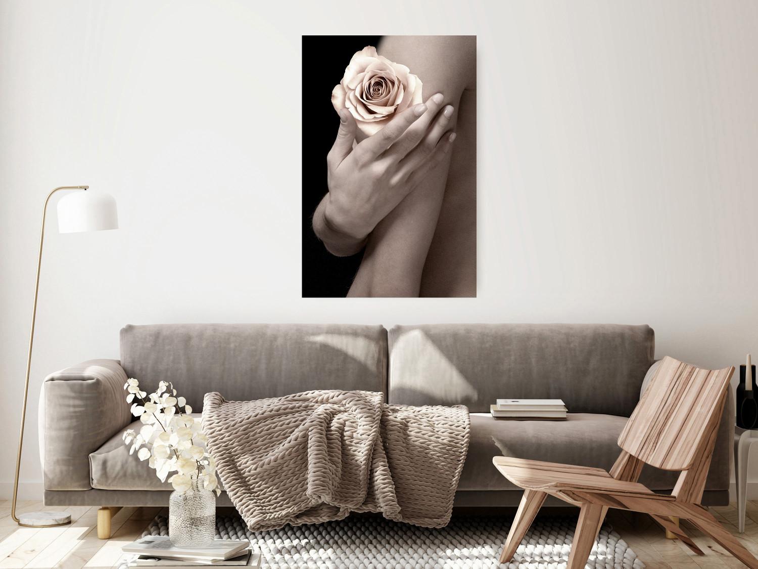 Poster Subtle Fragrance - woman's hand holding rose flower on black background