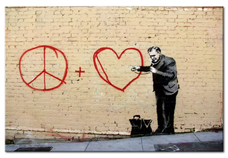 Peaceful Doctor (Banksy) - street art of a man on a brick wall