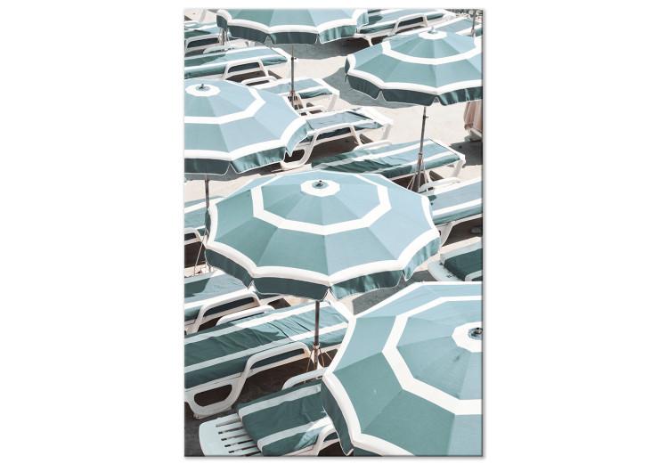 Turquoise sun loungers and umbrellas on the beach - seaside landscape