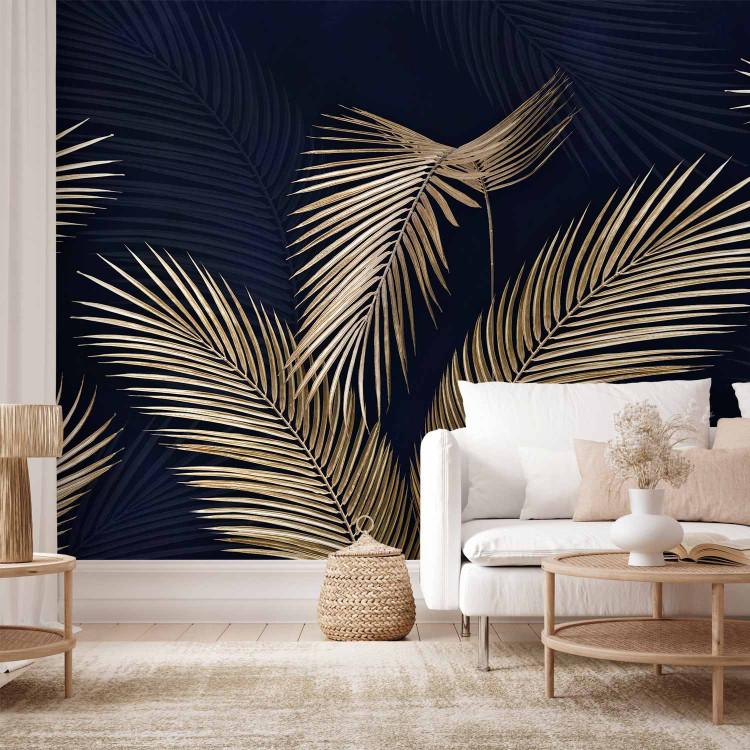 Wall Mural Golden Palm Trees - Graphics with Leaves in Yellow Colors on a Navy Blue Background
