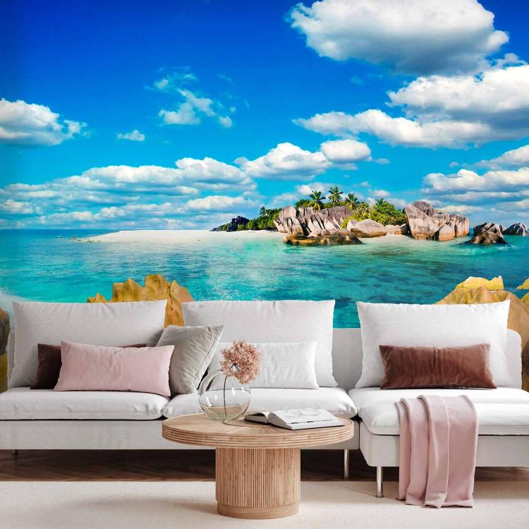 Wall Mural Deserted Island - Landscape with turquoise water, rocks, and palm trees