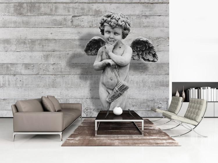 Wall Mural Charming stone cherub - angel sculpture against a background of concrete stripes