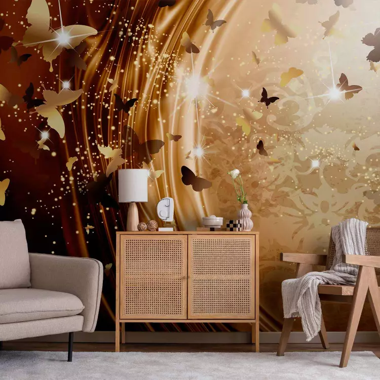 Wall Mural Abstraction - numerous butterflies full of glow on a golden background with ornaments