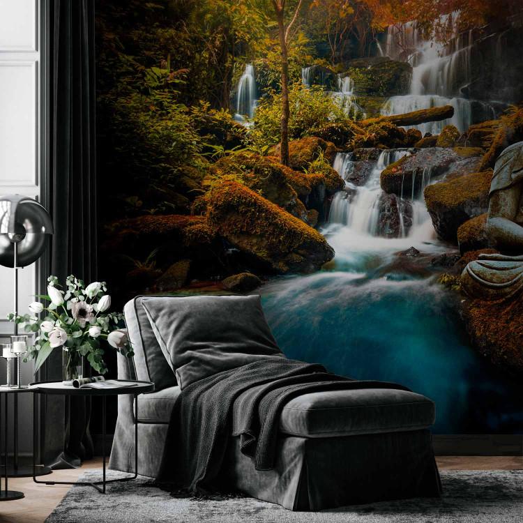 Wall Mural Orient - landscape with Buddha sculpture on a background of a waterfall and exotic forest