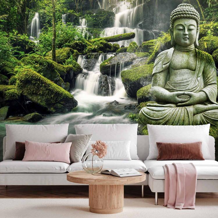 Wall Mural Orient in green - Buddha sculpture on a background of a waterfall and an exotic forest