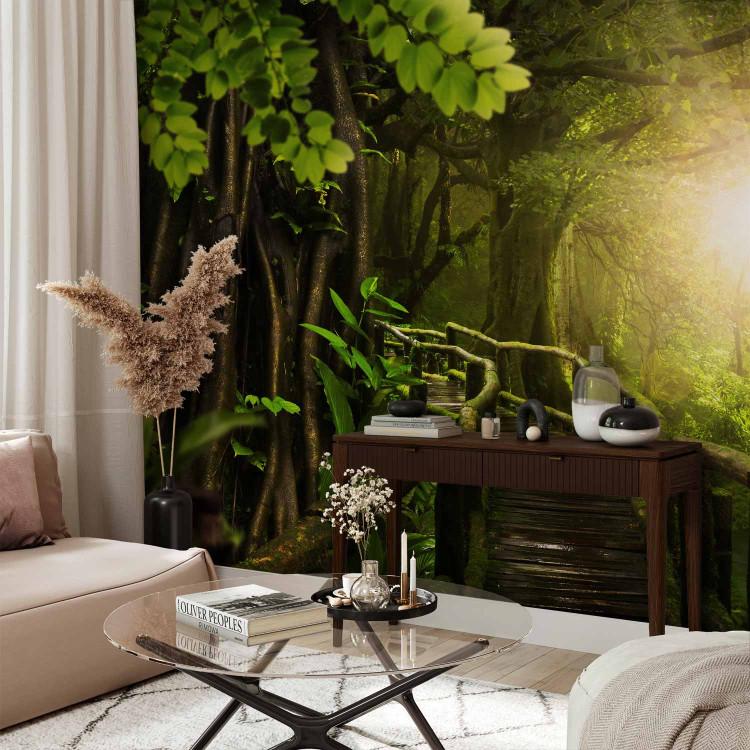 Wall Mural Jungle - green landscape with tropical forest and bridge towards the sun