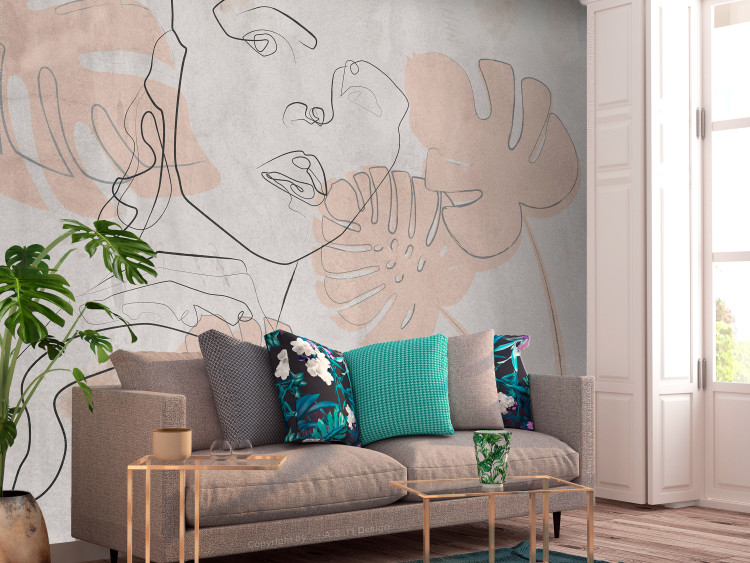 Wall Mural Delicate abstraction - outline of a woman's face on a background with pink leaves 134173